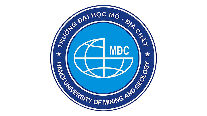 The logo consists of a light blue inner circle with a white sketch of a globe with the letters MDC and an outer dark blue circle with white text Hanoi University of Mining and Geology, Trường Đại học Mỏ - Địa chất Hà Nội.